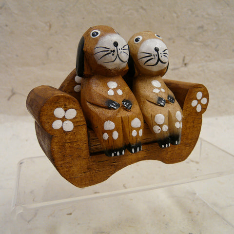 Two Dogs Sitting on Natural Wood Sofa decorated with Flowers