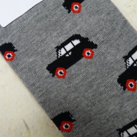 Close-up-of-grey-bamboo-socks-size-7-11-decorated-with-side-views-of-several-black-cabs-or-London-taxis-with-white-windows-and-red-wheels