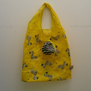 Yellow folding bag made from recycled plastic bottles, Zebra design, with pouch 