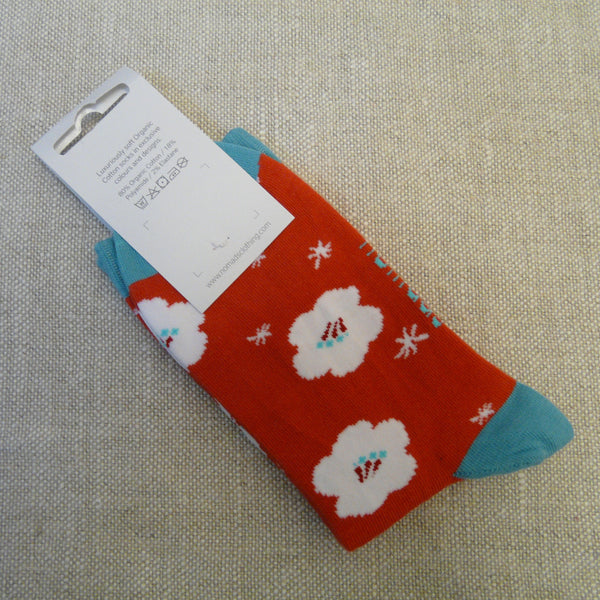 P1130732-Scarlet-Organic-Cotton-socks-4-7-white-Hybiscus-with-white-star-flowers-foot.-Sky-blue-toes-heels-and-tops